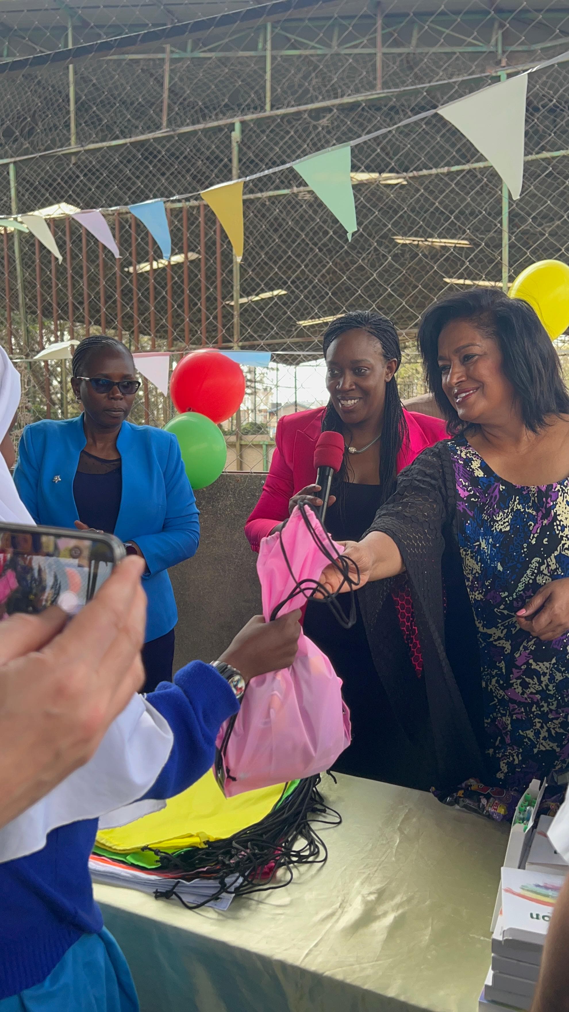 Passaris giving bags during charity event