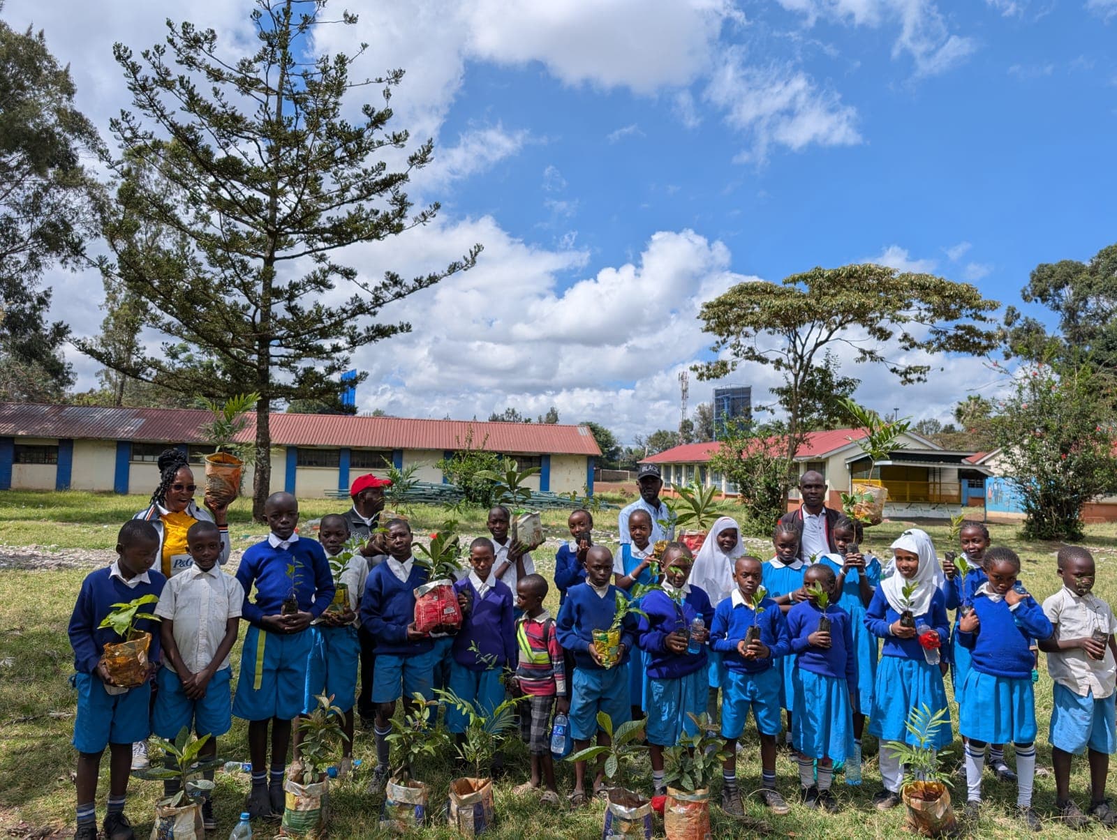 All students holding trees during environment day