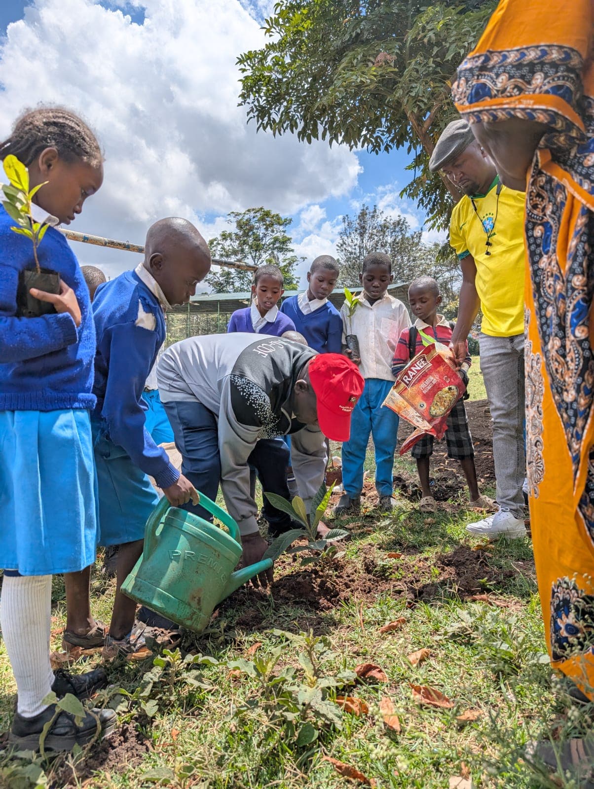 Students watering plants in the school garden